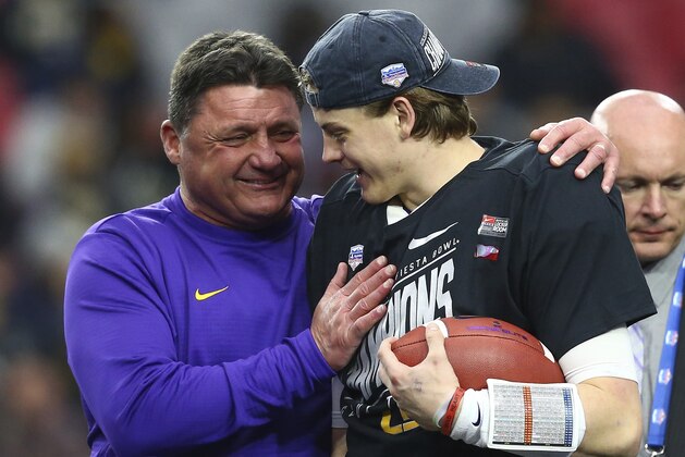 LSU head coach Ed Orgeron, left, celebrates a win against UCF with quarterback Joe Burrow, right, after a Fiesta Bowl NCAA college football game Tuesday, Jan. 1, 2019, in Glendale, Ariz. LSU defeated UCF 40-32. (AP Photo/Ross D. Franklin)