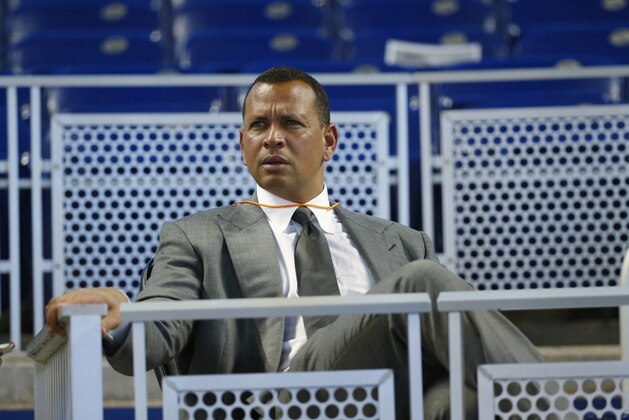 FILE - In this June 23, 2017, file photo, former baseball player Alex Rodriguez sits in the stands before the start of a baseball game in Miami. Rodriguez said he is happy with the improvements he has made in his second year in the booth for ESPN’s “Sunday Night Baseball”, but he is looking to get better during the second half of the season. (AP Photo/Wilfredo Lee, File)