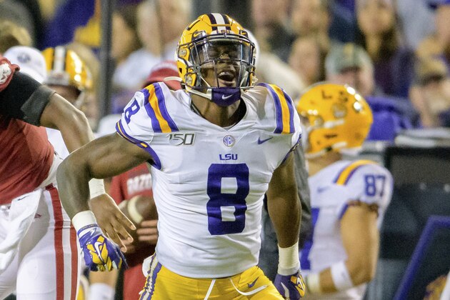 LSU linebacker Patrick Queen (8) takes part in an NCAA college football game against Arkansas in Baton Rouge, La., Saturday, Nov. 23, 2019. (AP Photo/Matthew Hinton)
