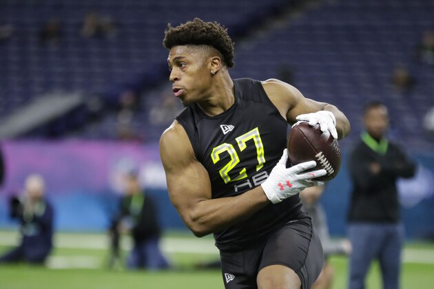 Wisconsin running back Jonathan Taylor runs a drill at the NFL football scouting combine in Indianapolis, Friday, Feb. 28, 2020. (AP Photo/Michael Conroy)