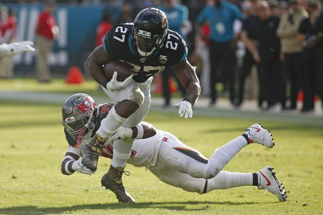 Jacksonville Jaguars running back Leonard Fournette (27) tries to get around Tampa Bay Buccaneers safety Mike Edwards, during the second half of an NFL football game Sunday, Dec. 1, 2019, in Jacksonville, Fla. (AP Photo/Stephen B. Morton)