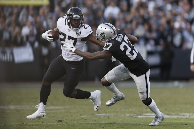 Jacksonville Jaguars running back Leonard Fournette (27) runs with the ball past Oakland Raiders cornerback Trayvon Mullen (27) during the second half of an NFL football game in Oakland, Calif., Sunday, Dec. 15, 2019. Jacksonville won the game 20-16. (AP Photo/D. Ross Cameron) Jacksonville Jaguars running back Leonard Fournette (27) runs with the ball past Oakland Raiders cornerback Trayvon Mullen (27) during the second half of an NFL football game in Oakland, Calif., Sunday, Dec. 15, 2019. Jacksonville won the game 20-16. (AP Photo/D. Ross Cameron)