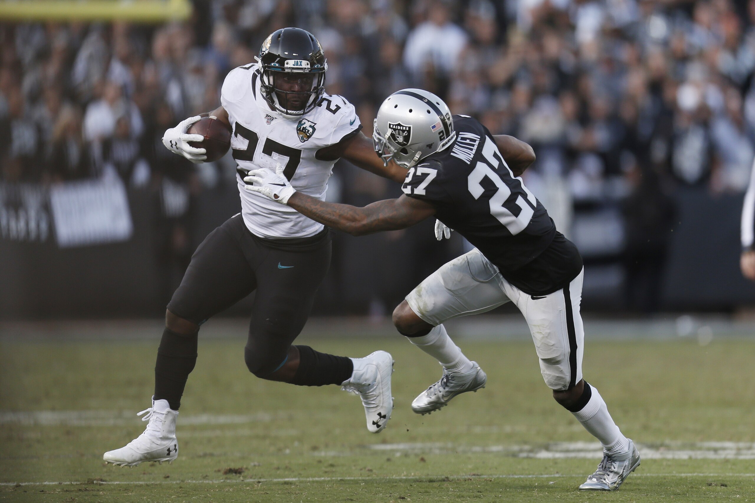 Jacksonville Jaguars running back Leonard Fournette (27) runs with the ball past Oakland Raiders cornerback Trayvon Mullen (27) during the second half of an NFL football game in Oakland, Calif., Sunday, Dec. 15, 2019. Jacksonville won the game 20-16. (AP Photo/D. Ross Cameron) Jacksonville Jaguars running back Leonard Fournette (27) runs with the ball past Oakland Raiders cornerback Trayvon Mullen (27) during the second half of an NFL football game in Oakland, Calif., Sunday, Dec. 15, 2019. Jacksonville won the game 20-16. (AP Photo/D. Ross Cameron)