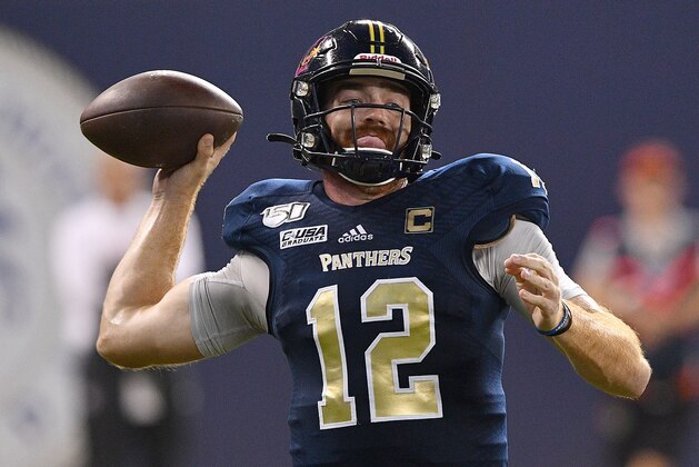 MIAMI, FLORIDA - NOVEMBER 23: James Morgan #12 of the FIU Golden Panthers looks to pass against the Miami Hurricanes in the second half at Marlins Park on November 23, 2019 in Miami, Florida. (Photo by Mark Brown/Getty Images)