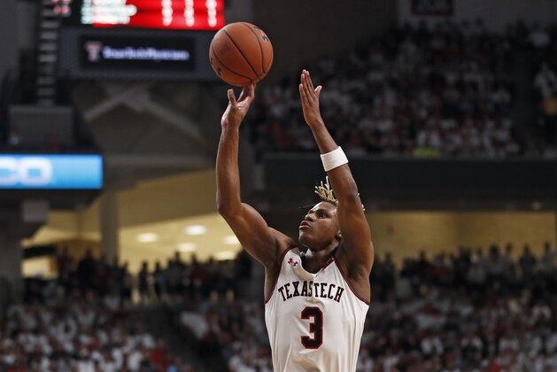 FILE - In this March 7, 2020, file photo, Texas Tech's Jahmi'us Ramsey shoots during the first half of an NCAA college basketball game against Kansas in Lubbock, Texas. Ramsey is exploring the NBA draft while keeping open his options to return to the Red Raiders. The school said Saturday, April 25, 2020, that Ramsey would enter his name in the draft without representation of an agent.  (AP Photo/Brad Tollefson, File)