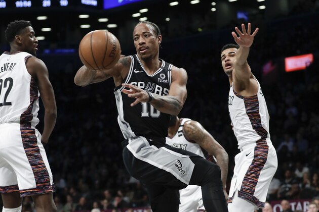 San Antonio Spurs' DeMar DeRozan (10) passes away from Brooklyn Nets' Timothe Luwawu-Cabarrot, right, during the first half of an NBA basketball game Friday, March 6, 2020, in New York. (AP Photo/Frank Franklin II) San Antonio Spurs' DeMar DeRozan (10) passes away from Brooklyn Nets' Timothe Luwawu-Cabarrot, right, during the first half of an NBA basketball game Friday, March 6, 2020, in New York. (AP Photo/Frank Franklin II)
