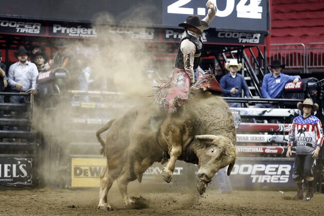 FILE - In this Feb. 11, 2017 file photo, Mason Lowe rides Cochise during a Professional Bull Riders event at the Sprint Center in Kansas City, Mo. Lowe died Tuesday, Jan. 15, 2019, after a bull stomped on his chest during a PBR chute-out competition at the National Western Stock Show in Denver. (AP Photo/Colin E. Braley, File)
