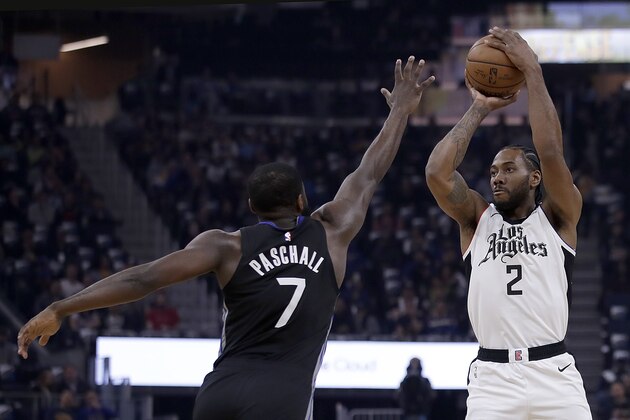 Los Angeles Clippers' Kawhi Leonard, right, shoots against Golden State Warriors' Eric Paschall (7) during the first half of an NBA basketball game Tuesday, March 9, 2020, in San Francisco. (AP Photo/Ben Margot)