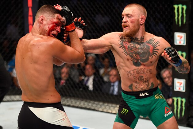 LAS VEGAS, NV - AUGUST 20:   (R-L) Conor McGregor of Ireland punches Nate Diaz in their welterweight bout during the UFC 202 event at T-Mobile Arena on August 20, 2016 in Las Vegas, Nevada. (Photo by Josh Hedges/Zuffa LLC/Zuffa LLC via Getty Images)
