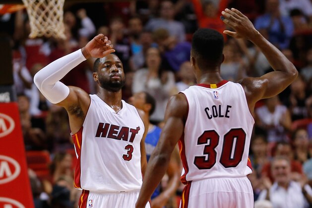 MIAMI, FL - DECEMBER 29: Dwyane Wade #3 of the Miami Heat high fives Norris Cole #30 of the Miami Heat during the game against the Orlando Magic at American Airlines Arena on December 29, 2014 in Miami, Florida. NOTE TO USER: User expressly acknowledges and agrees that, by downloading and or using this photograph, User is consenting to the terms and conditions of the Getty Images License Agreement.  (Photo by Christopher Trotman/Getty Images)