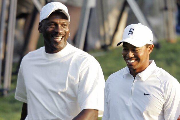 Tiger Woods, right, and Michael Jordan, left, share a laugh as they walk down the first fairway during the pro-am for the Wachovia Championship golf tournament at Quail Hollow Club in Charlotte, N.C., Wednesday, May 2, 2007. (AP Photo/Chuck Burton)