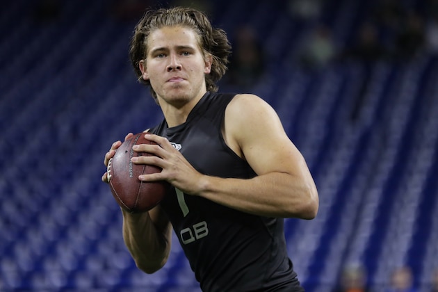 Oregon quarterback Justin Herbert runs a drill at the NFL football scouting combine in Indianapolis, Thursday, Feb. 27, 2020. (AP Photo/Michael Conroy)