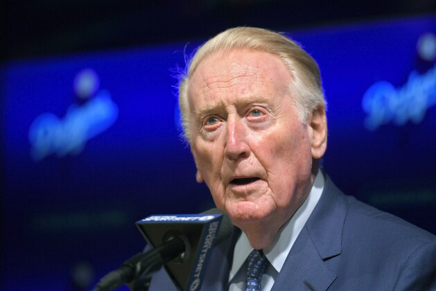 FILE - In this May 3, 2017 file photo, Hall of Fame broadcaster Vin Scully speaks to reporters about being inducted into the Los Angeles Dodgers Ring of Honor prior to a baseball game between the Dodgers and the San Francisco Giants in Los Angeles. Scully, 92, took a fall in his home Tuesday, April 21, 2020, and was taken to the hospital, where he was