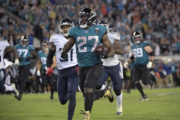 Jacksonville Jaguars running back Leonard Fournette (27) rushes for a 69-yard gain in front of Tennessee Titans free safety Kevin Byard (31) during the second half of an NFL football game Thursday, Sept. 19, 2019, in Jacksonville, Fla. (AP Photo/Phelan M. Ebenhack)