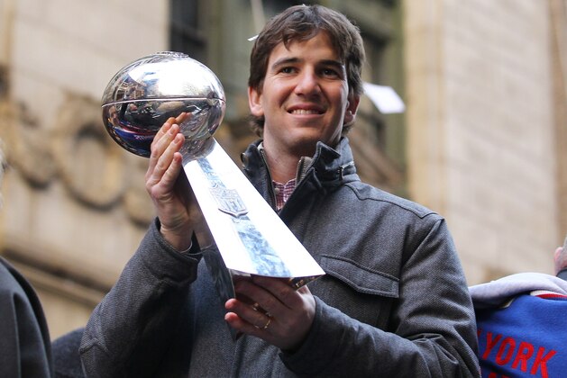 NEW YORK, NY - FEBRUARY 07:  Eli Manning #10 of the New York Giants holds the Vince Lombardi Trophy during the New York Giants' ticker tape victory parade down the Canyon of Heros on February 7, 2012 in New York City.  The Giants defeated the New England Patriots 21-17 in Super Bowl XLVI at Lucas Oil Stadium on February 5, 2012 in Indianapolis, Indiana.  (Photo by Al Bello/Getty Images)