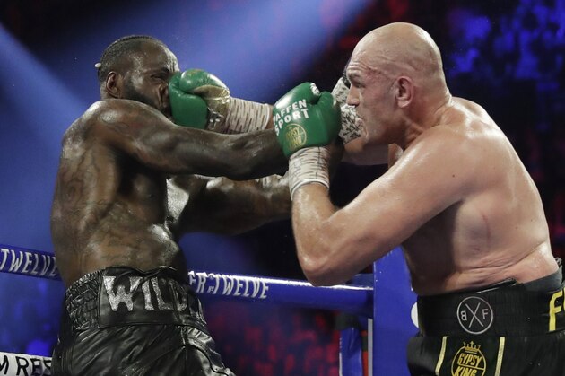 Tyson Fury, of England, lands a right to Deontay Wilder during a WBC heavyweight championship boxing match Saturday, Feb. 22, 2020, in Las Vegas. (AP Photo/Isaac Brekken)