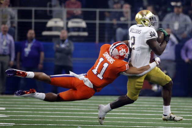 Clemson safety Isaiah Simmons (11) attempts to stop Notre Dame running back Dexter Williams (2) from gaining more yardage in the first half of the NCAA Cotton Bowl semi-final playoff football game, Saturday, Dec. 29, 2018, in Arlington, Texas. (AP Photo/Michael Ainsworth)