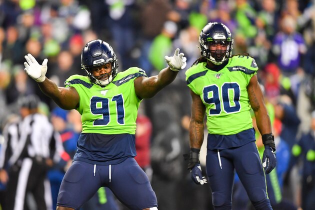 SEATTLE, WASHINGTON - DECEMBER 02: Jarran Reed #91 of the Seattle Seahawks, left, dances, and Jadeveon Clowney #90 looks at the Minnesota Vikings sidelines after a defensive stop during the game against the Minnesota Vikings at CenturyLink Field on December 02, 2019 in Seattle, Washington. The Seattle Seahawks won, 37-30. (Photo by Alika Jenner/Getty Images)
