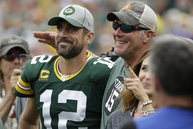 Green Bay Packers' Aaron Rodgers smiles with former quarterback Brett Favre during halftime of an NFL football game against the Minnesota Vikings Sunday, Sept. 15, 2019, in Green Bay, Wis. (AP Photo/Mike Roemer)