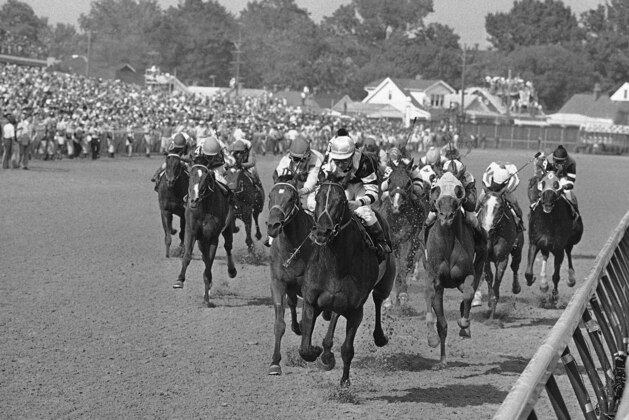 FILE - In this May 7, 1977, file photo, Seattle Slew, with Jean Cruguet up, crosses finish line to win the Kentucky Derby horse race at Churchill Downs in Louisville, Ky. Run Dusty Run, left of Seattle Slew, finished second, and Sanhedrin, just to right of Seattle Slew, finished third. Secretariat is the early 7-2 favorite for this weekendâ€™s virtual Kentucky Derby, an animated race pitting all 13 Triple Crown winners on the day the Derby would have been held before the coronavirus pandemic postponed it. Citation, who won the 1948 Triple Crown, was made the 4-1 second choice. Seattle Slew and Affirmed, the 1977 and '78 Triple Crown winners, were each listed at 5-1 odds. (AP Photo/File)