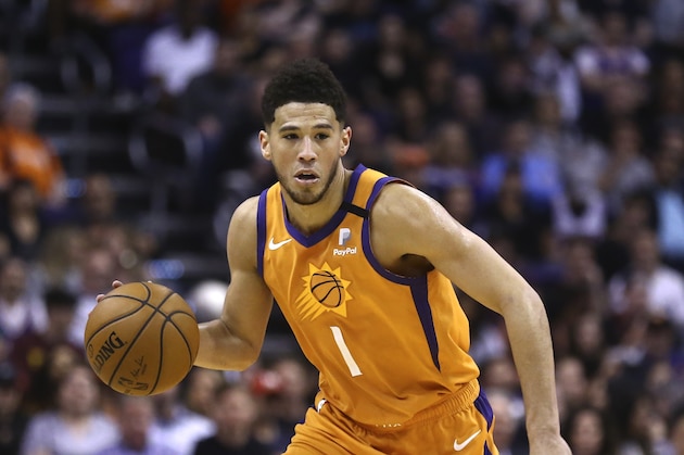 Phoenix Suns guard Devin Booker dribbles the ball against the Portland Trail Blazers during the second half of an NBA basketball game Friday, March 6, 2020, in Phoenix. The Suns defeated the Trail Blazers 127-117. (AP Photo/Ross D. Franklin)