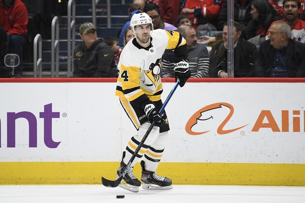 Pittsburgh Penguins defenseman Justin Schultz (4) skates with the puck during the second period of an NHL hockey game against the Washington Capitals, Sunday, Feb. 23, 2020, in Washington. (AP Photo/Nick Wass)