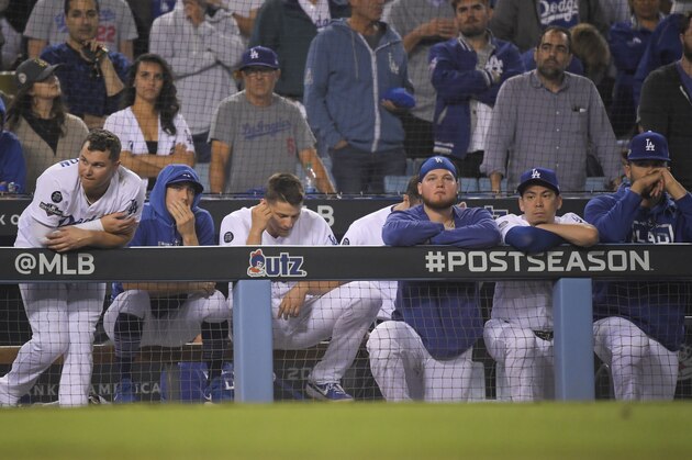 Members of the Los Angeles Dodgers react to the team's 7-3 loss in 10 innings to the Washington Nationals in Game 5 of a baseball National League Division Series on Wednesday, Oct. 9, 2019, in Los Angeles. (AP Photo/Mark J. Terrill)