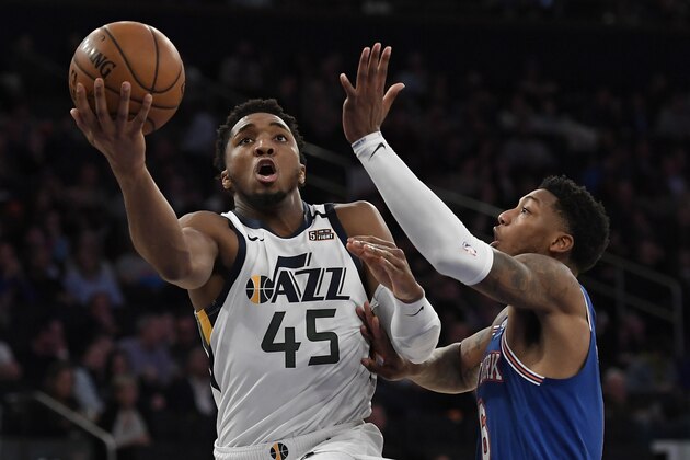 Utah Jazz guard Donovan Mitchell (45) shoots next to New York Knicks guard Elfrid Payton during the second half of an NBA basketball game in New York, Wednesday, March 4, 2020. (AP Photo/Sarah Stier)