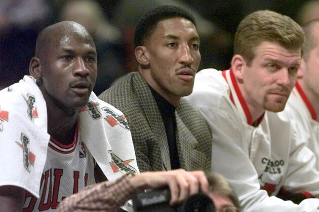 Chicago Bulls' injured player Scottie Pippen sits on the bench between teammates Michael Jordan, left and Joe Kleine in the first period against the Milwaukee Bucks, Friday Dec. 5, 1997, in Chicago. (AP Photo/Michael S. Green)