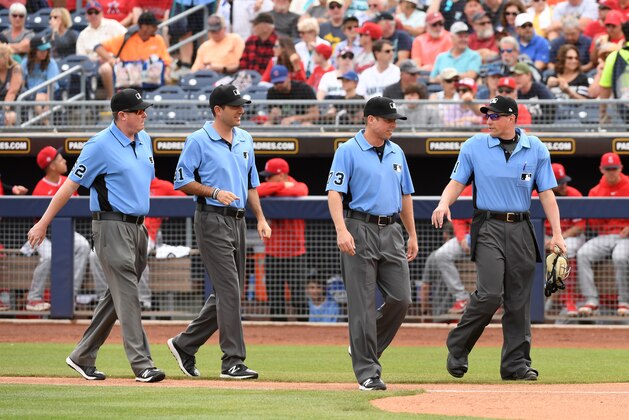 PEORIA, ARIZONA - MARCH 10: Home plate umpire Quinn Wolcott #81 and umpires Tripp Gibson #73, Pat Hoberg #31 and Chad Whitson #62 walk to home plate prior to the start of a spring training game between the Seattle Mariners and the Los Angeles Angels at Peoria Stadium on March 10, 2020 in Peoria, Arizona. (Photo by Norm Hall/Getty Images)