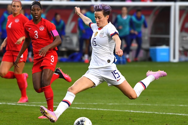 CARSON, CA - FEBRUARY 09:     Kadeisha Buchanan #3 of Canada looks on as Megan Rapinoe #15 of the United States kicks the ball into the net for a goal in the second half of the CONCACAF Women's Olympic Qualifying Final at Dignity Health Sports Park on February 9, 2020 in Carson, California. (Photo by Jayne Kamin-Oncea/Getty Images)