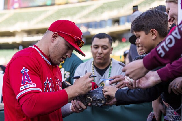 Los Angeles Angels Mike Trout signs autographs before a baseball game against the Oakland Athletics, Saturday, March 30, 2019 in Oakland, Calif. (AP Photo/John Hefti)