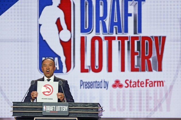NBA Deputy Commissioner Mark Tatum announces that the Atlanta Hawks won the 10th pick during the NBA basketball draft lottery, Tuesday, May 14, 2019, in Chicago. (AP Photo/Nuccio DiNuzzo)
