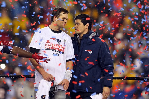 FOXBORO, MA - JANUARY 18:  Tom Brady #12 of the New England Patriots looks on with former Patriot Tedy Bruschi after defeating the Indianapolis Colts in the 2015 AFC Championship Game at Gillette Stadium on January 18, 2015 in Foxboro, Massachusetts. The Patriots defeated the Colts 45-7. (Photo by Jim Rogash/Getty Images)