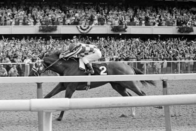 FILE - In this June 9, 1973, file photo, jockey Ron Turcotte hangs on as Secretariat romps along the final stretch just before the finish line and a victory in the 105th running of the Belmont Stakes, winning the Triple Crown at Belmont Park in Elmont, N.Y. When Justify runs in the Belmont on Saturday, June 9, 2018, it will be 45 years to the day Secretariat ended a 25-year Triple Crown drought by sweeping the Kentucky Derby, Preakness and Belmont.(AP Photo/File)