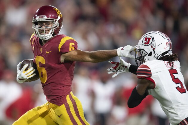 Southern California wide receiver Michael Pittman Jr., left, sprints with the ball past Utah defensive back Tareke Lewis during an NCAA football game on Friday, Sept. 20, 2019 in Los Angeles. (AP Photo/Kyusung Gong)