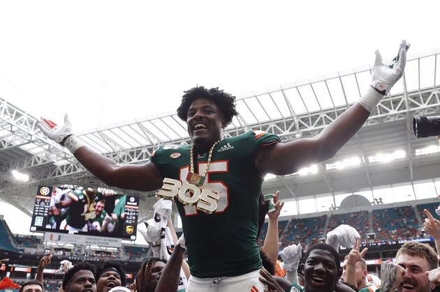 FILE - In this Sept. 21, 2019, file photo, Miami defensive lineman Gregory Rousseau (15) celebrates a turnover and wears the turnover chain during the first half of an NCAA college football game against Central Michigan, in Miami Gardens, Fla. Rousseau was selected to The Associated Press All-Atlantic Coast Conference football team, Tuesday, Dec. 10, 2019. (AP Photo/Brynn Anderson, File)