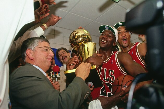 PHOENIX - JUNE 20: NBA Commissioner David Stern presents Michael Jordan and the Chicago Bulls the championship trophy after the Bulls defeated the Phoenix Suns in Game Six of the 1993 NBA Finals on June 20, 1993 at America West Arena in Phoenix, Arizona. NOTE TO USER: User expressly acknowledges and agrees that, by downloading and or using this photograph, User is consenting to the terms and conditions of the Getty Images License Agreement. Mandatory Copyright Notice: Copyright 1993 NBAE (Photo by Andrew D. Bernstein/NBAE via Getty Images)