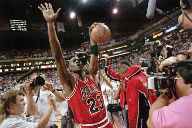 The Chicago Bulls Michael Jordan celebrates after the Bulls beat the Phoenix Suns 99-98 to win their third consecutive NBA title in Phoenix, June 20, 1993. Jordan scored 33 points and now holds the record for the highest scoring average in finals history, 41.0, eclipsing Rick Barry's 1967 standard of 40.8. (AP Photo/John Swart)