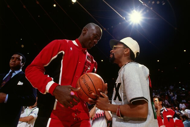 INGLEWOOD, CA- JUNE 12: Michael Jordan #23 of the Chicago Bulls talks with Spike Lee during Game Five of the 1991 NBA Finals on June 12, 1991 at the Great Western Forum in Inglewood, California. NOTE TO USER: User expressly acknowledges and agrees that, by downloading and/or using this Photograph, user is consenting to the terms and conditions of the Getty Images License Agreement. Mandatory Copyright Notice: Copyright 1991 NBAE (Photo by Andrew D. Bernstein/NBAE via Getty Images)