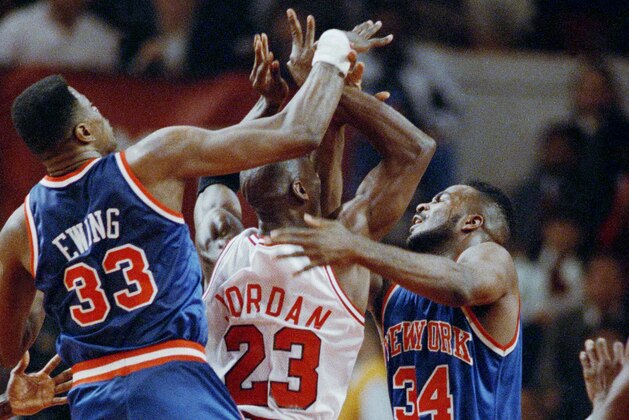 The Chicago Bulls Michael Jordan (23) gets caught between the New York Knicks Patrick Ewing (33) and Charles Oakley (34) during the third quarter of a playoff game, Tuesday, May 5, 1992, Chicago, Ill. The Knicks held on to beat the Bulls 94-89 to go up 1-0 in the best-of-seven series. (AP Photo/John Swart)