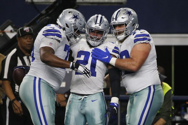 Dallas Cowboys running back Ezekiel Elliott (21) celebrates a touchdown catch with teammates during the first half of an NFL football game against the Washington Redskins in Arlington, Texas, Sunday, Dec. 15, 2019. (AP Photo/Michael Ainsworth)