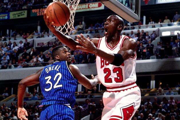CHICAGO - MAY 12:  Michael Jordan #23 of the Chicago Bulls attempts a layup against Shaquille O'Neal #32 of Orlando Magic during Game Three of the 1995 Easter Conference Semi-Finals at the United Center on May 12, 1995 in Chicago, Illinois.  NOTE TO USER: User expressly acknowledges that, by downloading and or using this photograph, User is consenting to the terms and conditions of the Getty Images License agreement. Mandatory Copyright Notice: Copyright 1995 NBAE (Photo by Barry Gossage/NBAE via Getty Images)