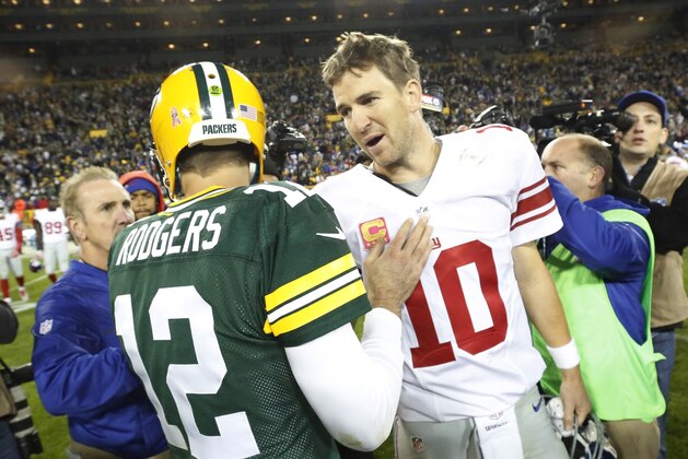 Green Bay Packers' Aaron Rodgers talks to New York Giants' Eli Manning after an NFL football game Sunday, Oct. 9, 2016, in Green Bay, Wis. The Packers won 23-16. (AP Photo/Mike Roemer)