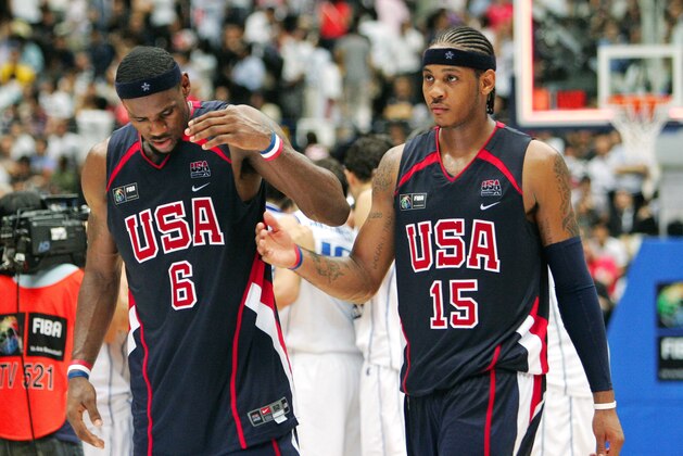 USA's LeBron James (6), left, and Carmelo Anthony (15) walk off the floor as Greece's team celebrates in the background, following the semifinals of the World Basketball Championships in Saitama, Japan, Friday, Sept. 1, 2006. Greece defeated USA 101-95. (AP Photo/Mark J. Terrill)