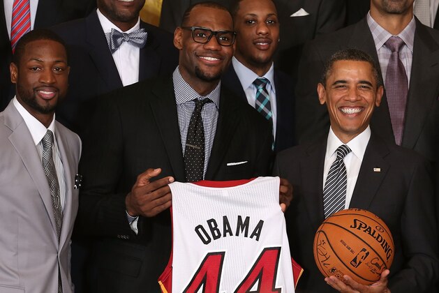 WASHINGTON, DC - JANUARY 28: U.S. President Barack Obama (R) stands with Miami Heat players, including Dwyane Wade (L), LeBron James (2nd-L), Mario Chalmers (2R) during an event to honor the NBA champion Miami Heat in the East Room at the White House on January 28, 2013 in Washington, DC. President Barack Obama congratulated the 2012 NBA champions for claiming their third NBA Championship by beating the Boston Celtics.  (Photo by Mark Wilson/Getty Images)