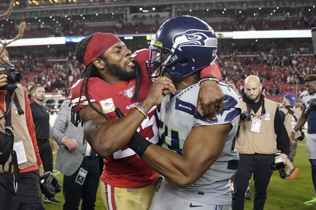San Francisco 49ers cornerback Richard Sherman, left, hugs Seattle Seahawks middle linebacker Bobby Wagner after an NFL football game in Santa Clara, Calif., Monday, Nov. 11, 2019. The Seahawks won 27-24 in overtime. (AP Photo/Tony Avelar)