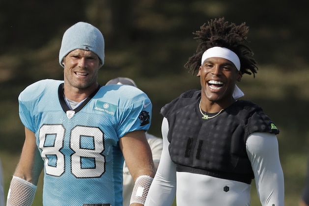 Carolina Panthers players Cam Newton, right, and Greg Olsen, left, arrive before practice at the NFL football team's training camp in Spartanburg, S.C., Sunday, July 28, 2019. (AP Photo/Chuck Burton)