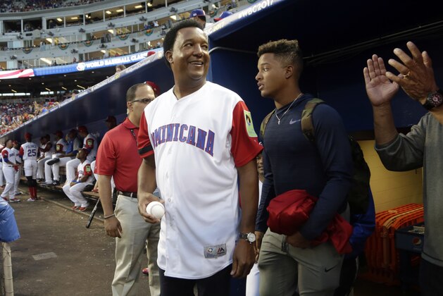 Former Major League Baseball pitcher Pedro Martinez, center, waits in the dugout before throwing out a ceremonial pitch before a first-round game of the World Baseball Classic between the United States and the Dominican Republic, Saturday, March 11, 2017, in Miami. (AP Photo/Lynne Sladky) Former Major League Baseball pitcher Pedro Martinez, center, waits in the dugout before throwing out a ceremonial pitch before a first-round game of the World Baseball Classic between the United States and the Dominican Republic, Saturday, March 11, 2017, in Miami. (AP Photo/Lynne Sladky)