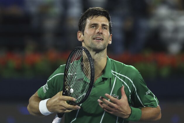 Serbia's Novak Djokovic celebrates after he beats Stefanos Tsitsipas of Greece in the final match of the Dubai Duty Free Tennis Championship in Dubai, United Arab Emirates, Saturday, Feb. 29, 2020. (AP Photo/Kamran Jebreili)